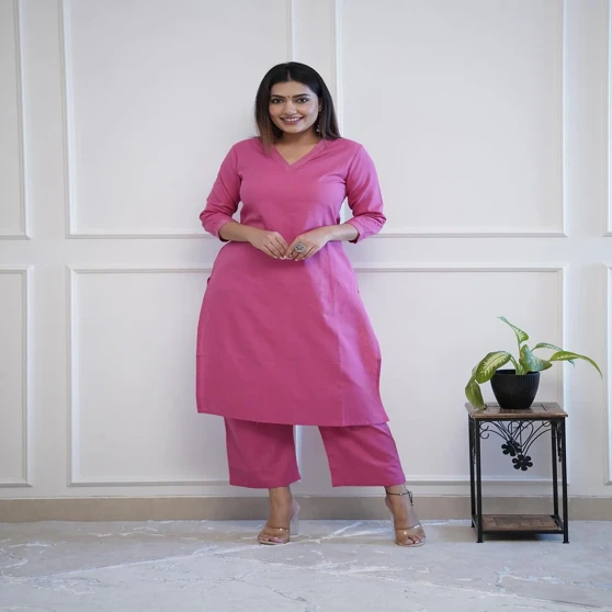 Women posing with trendy pink co-ord set